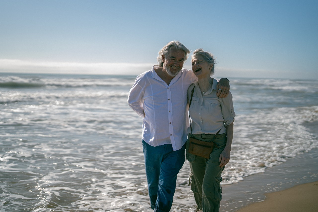 ouder stel wandelt op strand