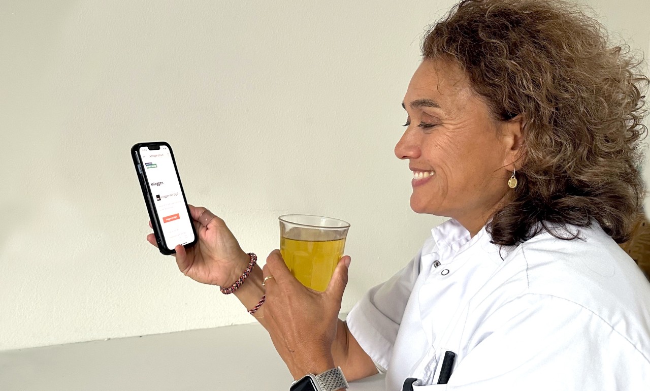 Verpleegkundige kijkt op mobiele telefoon